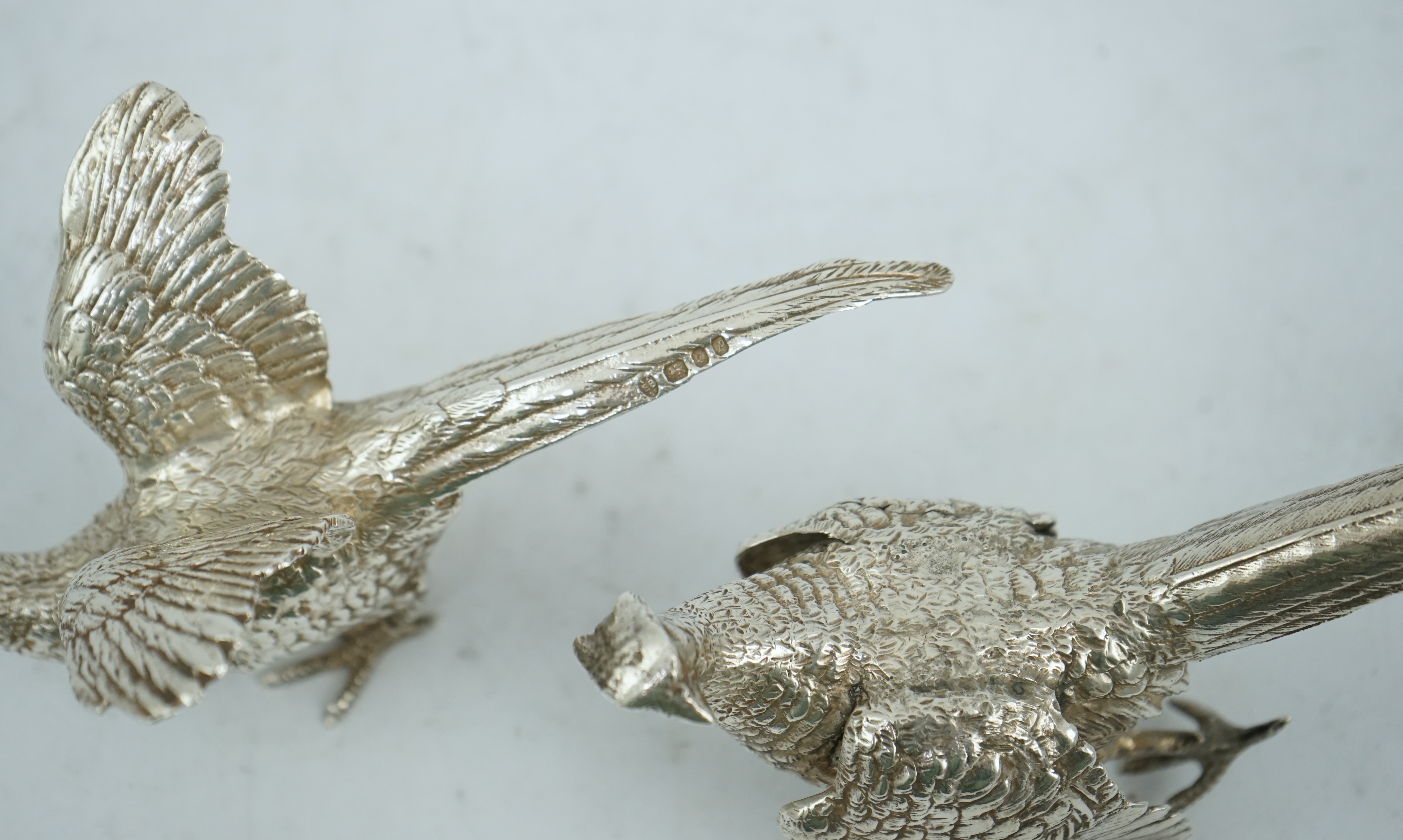 A pair of Elizabeth II silver free-standing model pheasants, by Edward Barnard & Sons Ltd